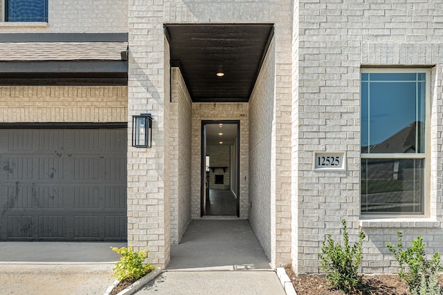 doorway to property with a garage