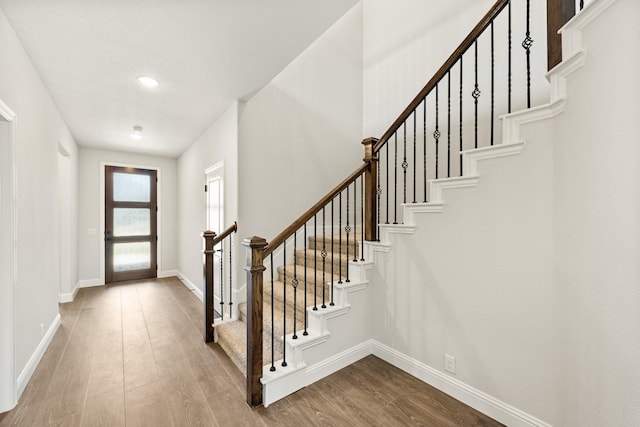 entrance foyer featuring stairway, baseboards, recessed lighting, and wood finished floors