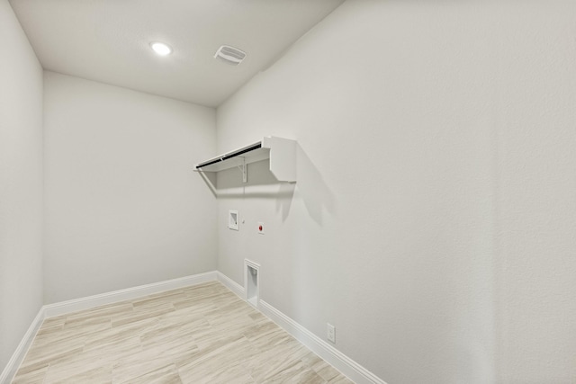 clothes washing area featuring washer hookup, laundry area, baseboards, hookup for a gas dryer, and electric dryer hookup