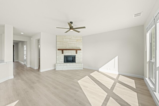 12736 Ruger Rd, Godley, TX 76044 - unfurnished living room featuring a ceiling fan, visible vents, a fireplace, baseboards, and light wood-style flooring