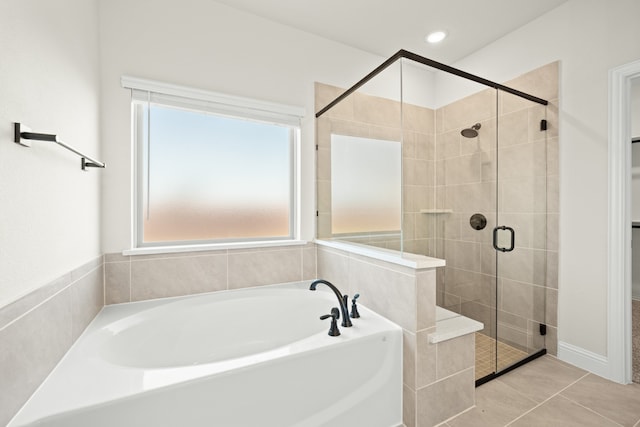 bathroom with independent shower and bath and tile patterned flooring