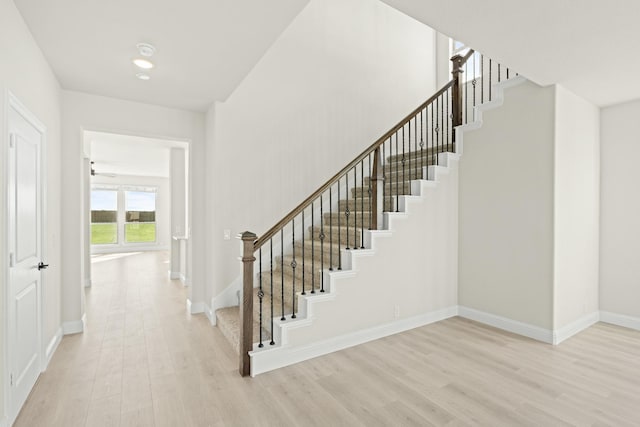 stairs featuring baseboards and wood finished floors