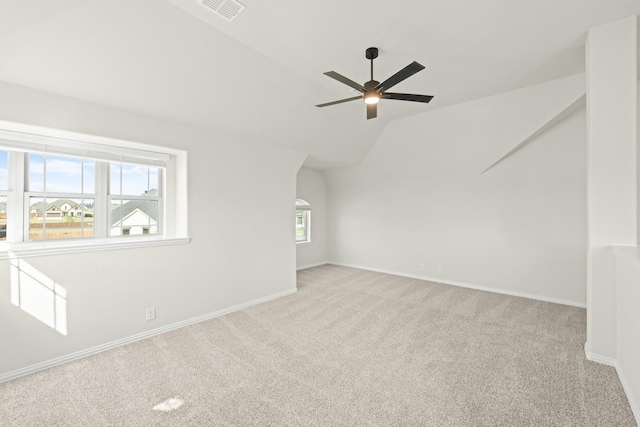 bonus room with carpet floors, visible vents, baseboards, a ceiling fan, and vaulted ceiling