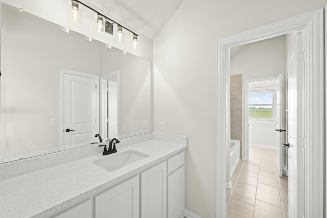 bathroom with vanity, baseboards, walk in shower, a bathtub, and tile patterned floors