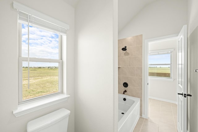 bathroom featuring shower / bath combination, tile patterned flooring, vaulted ceiling, and toilet