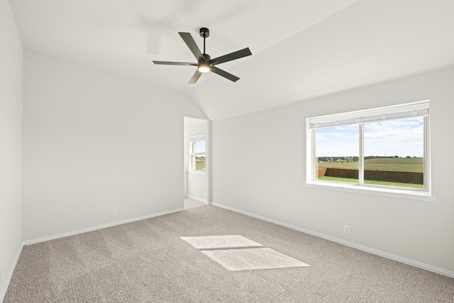 spare room featuring a healthy amount of sunlight, baseboards, ceiling fan, and carpet