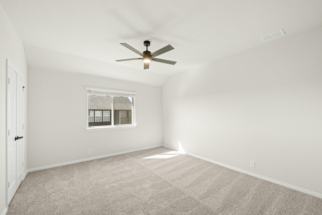 empty room with baseboards, ceiling fan, carpet flooring, and visible vents