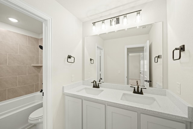 full bath featuring a sink, toilet, double vanity, and tub / shower combination