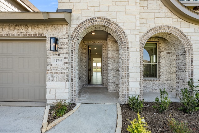 view of exterior entry with a garage