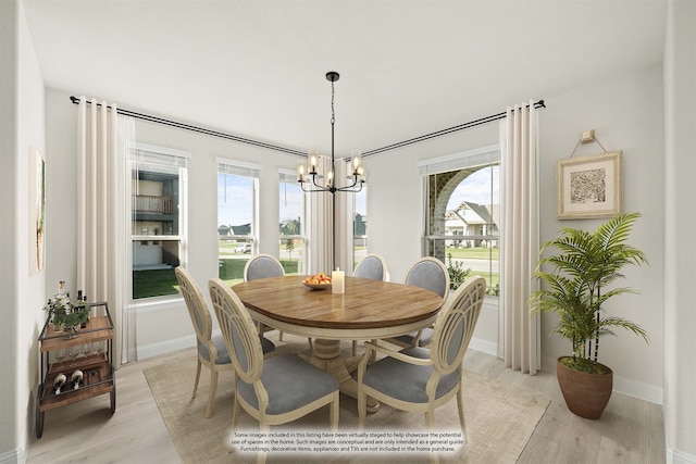 dining area with a healthy amount of sunlight, light hardwood / wood-style flooring, and a chandelier