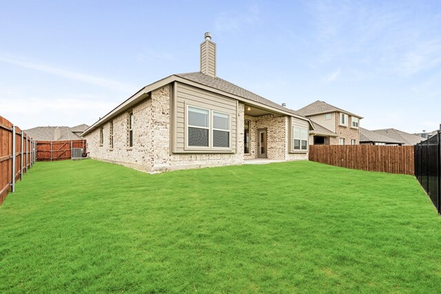 rear view of house with a yard and central AC