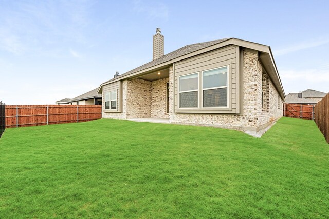 rear view of property with a yard