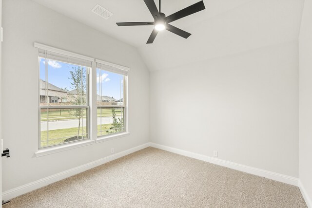 unfurnished room featuring vaulted ceiling, ceiling fan, and carpet