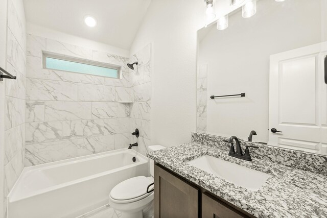 full bathroom featuring vanity, vaulted ceiling, toilet, and tiled shower / bath