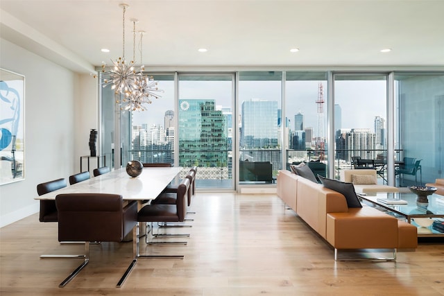 dining area featuring a wall of windows, a wealth of natural light, and light hardwood / wood-style flooring