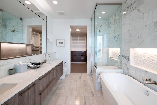 full bathroom with vanity, independent shower and bath, and toilet