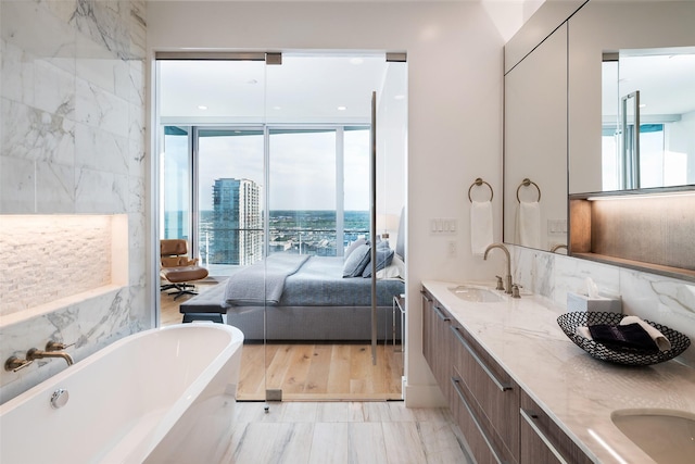 bathroom featuring a washtub and vanity