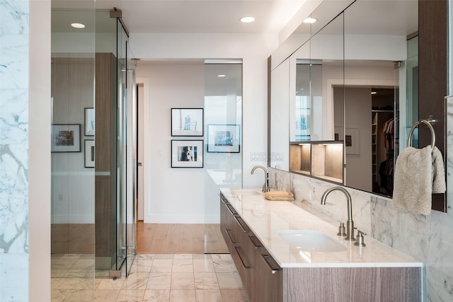 bathroom featuring vanity and a shower with shower door