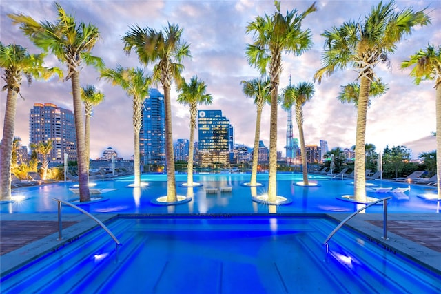 view of pool at dusk