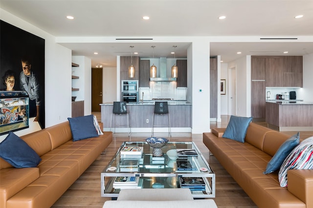 living room with sink and light hardwood / wood-style floors