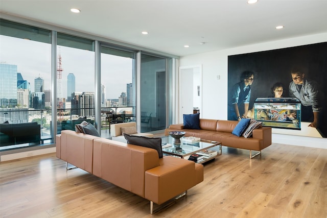 living room featuring floor to ceiling windows and light wood-type flooring