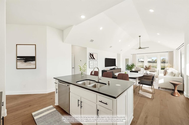 kitchen featuring white cabinetry, sink, ceiling fan, stainless steel dishwasher, and an island with sink