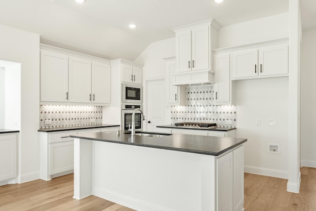 kitchen with white cabinetry, a center island with sink, and appliances with stainless steel finishes