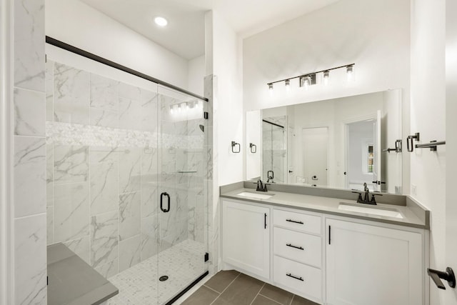 bathroom featuring tile patterned floors, vanity, and an enclosed shower