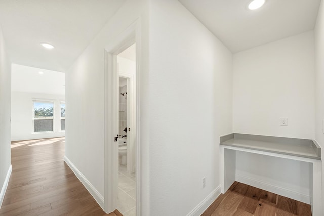 hallway with hardwood / wood-style flooring