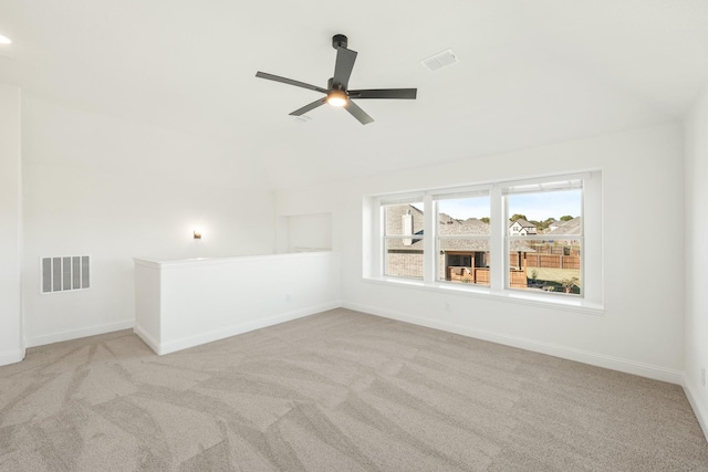 empty room with ceiling fan and light colored carpet