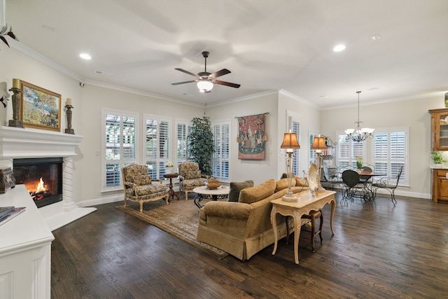 living room with ceiling fan with notable chandelier, a healthy amount of sunlight, ornamental molding, and dark hardwood / wood-style floors