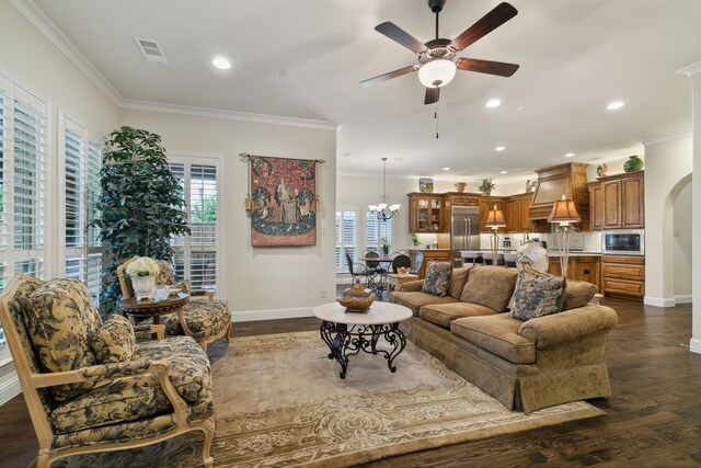 living room featuring sink, dark wood-type flooring, ceiling fan with notable chandelier, and ornamental molding