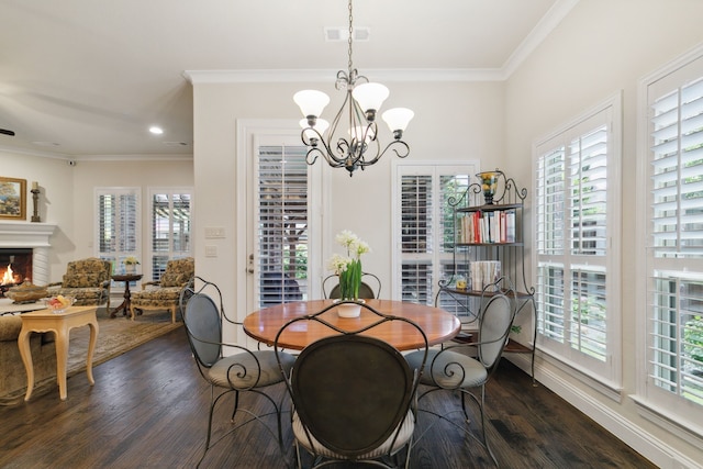 dining area featuring dark hardwood / wood-style flooring, crown molding, and a notable chandelier