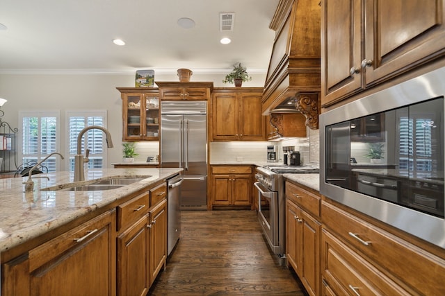 kitchen featuring sink, dark hardwood / wood-style floors, backsplash, crown molding, and high quality appliances