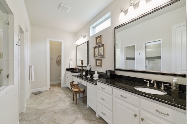 bathroom featuring vanity, toilet, and an enclosed shower