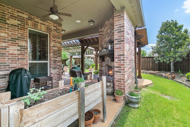 view of patio featuring grilling area, an outdoor brick fireplace, and ceiling fan