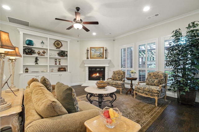 living room with dark hardwood / wood-style flooring, ceiling fan, and ornamental molding