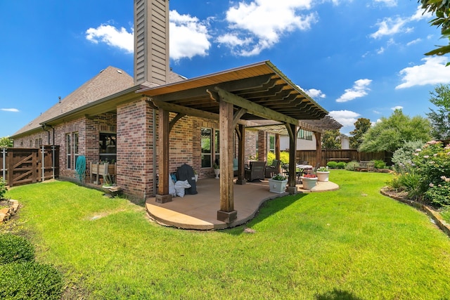 rear view of house with a yard and a patio