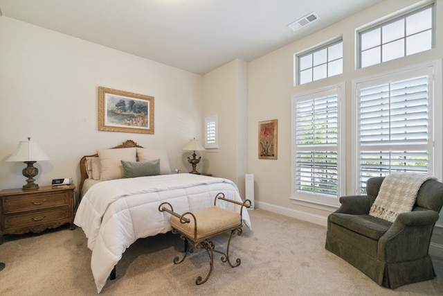 bedroom featuring light carpet