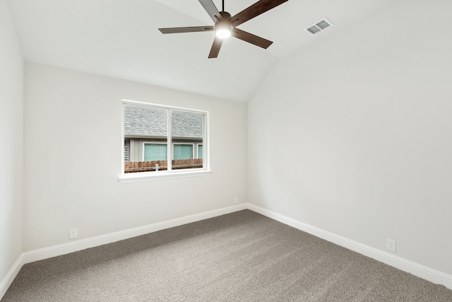 empty room with carpet and vaulted ceiling