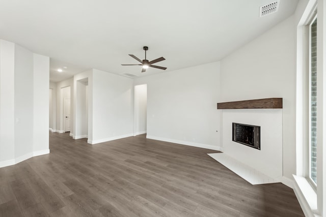 unfurnished living room with ceiling fan and dark hardwood / wood-style flooring