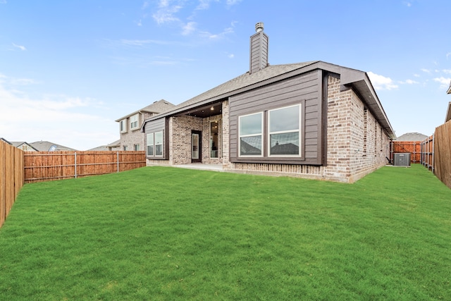 back of house with a lawn, cooling unit, and a patio