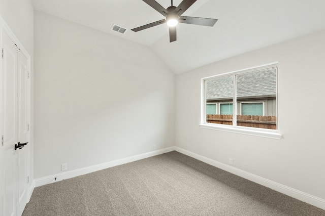 empty room with carpet, vaulted ceiling, and ceiling fan