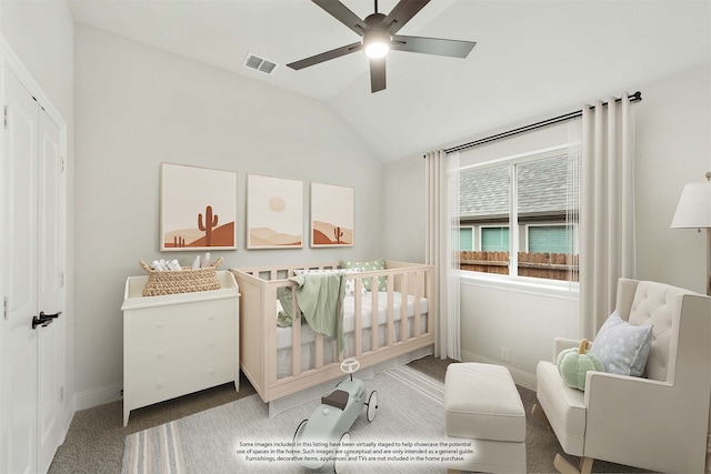 bedroom featuring lofted ceiling, carpet flooring, ceiling fan, and a nursery area