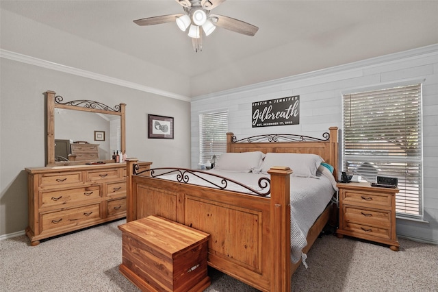 carpeted bedroom featuring ceiling fan, ornamental molding, and multiple windows