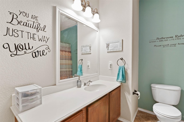 bathroom featuring walk in shower, tile patterned flooring, vanity, and toilet