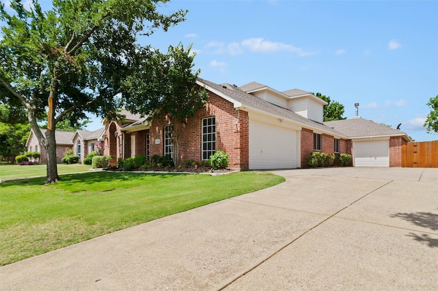 view of front facade with a front yard and a garage