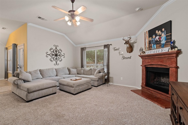 carpeted living room with ceiling fan, vaulted ceiling, and ornamental molding