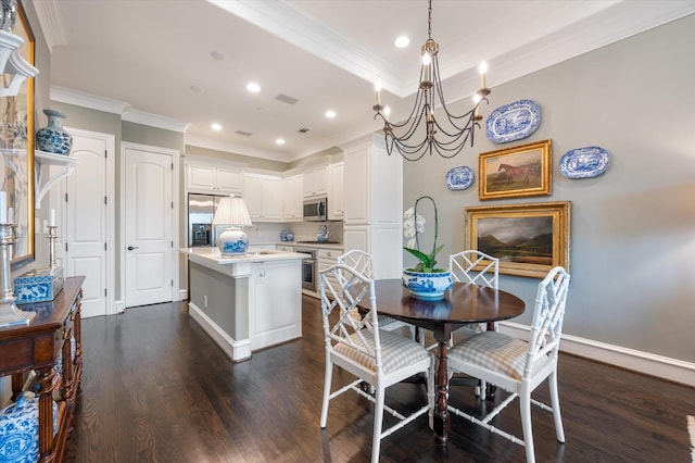 dining room with an inviting chandelier, crown molding, and dark hardwood / wood-style flooring