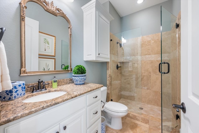 bathroom with an enclosed shower, vanity, and toilet